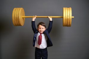 Enfant soulevant un haltère en or